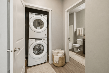 Stacked washer and dryer unit in hallway closet